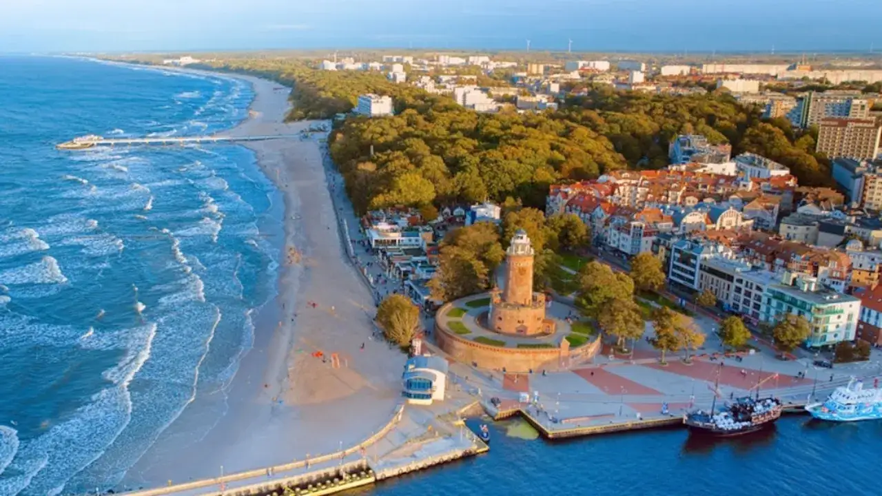 Widok na plażę, molo i latarnię morską. Miasto nad morzem, gdzie ceny mogą zaskoczyć.